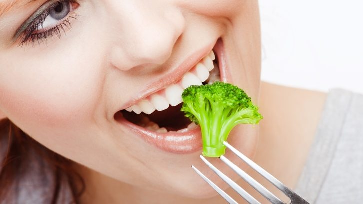 Girl eating Broussels sprout